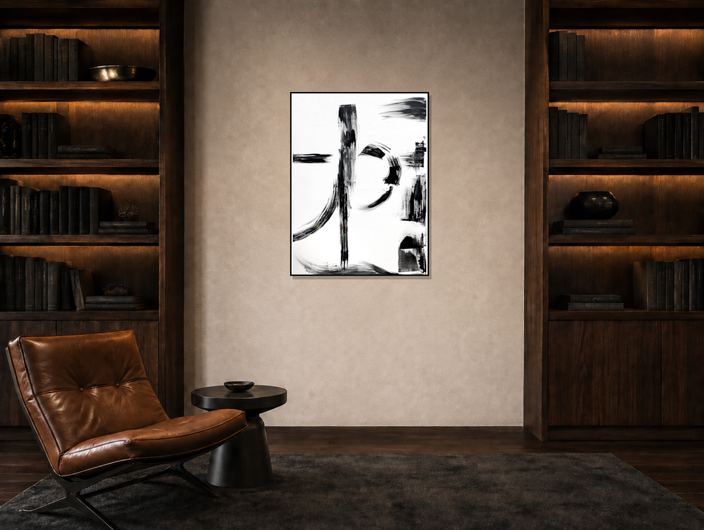 A framed abstract black and white calligraphic wall art print is displayed in a modern, symmetrical study with dark wood bookshelves, a brown leather chair, and a dark rug.