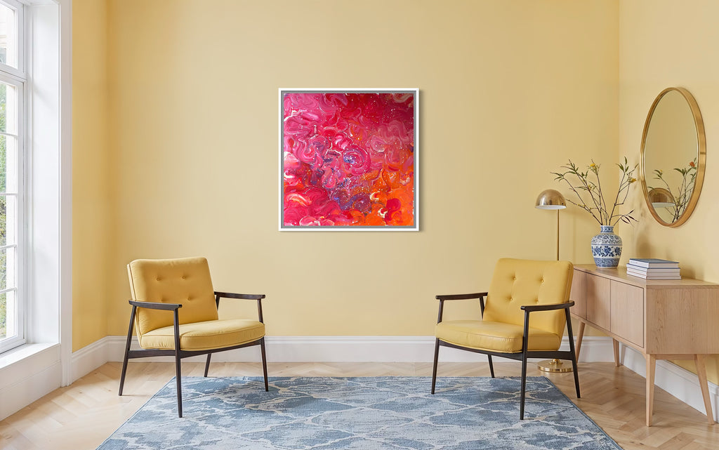 Living room with yellow walls, two yellow chairs, a blue rug, and a colorful abstract painting.
