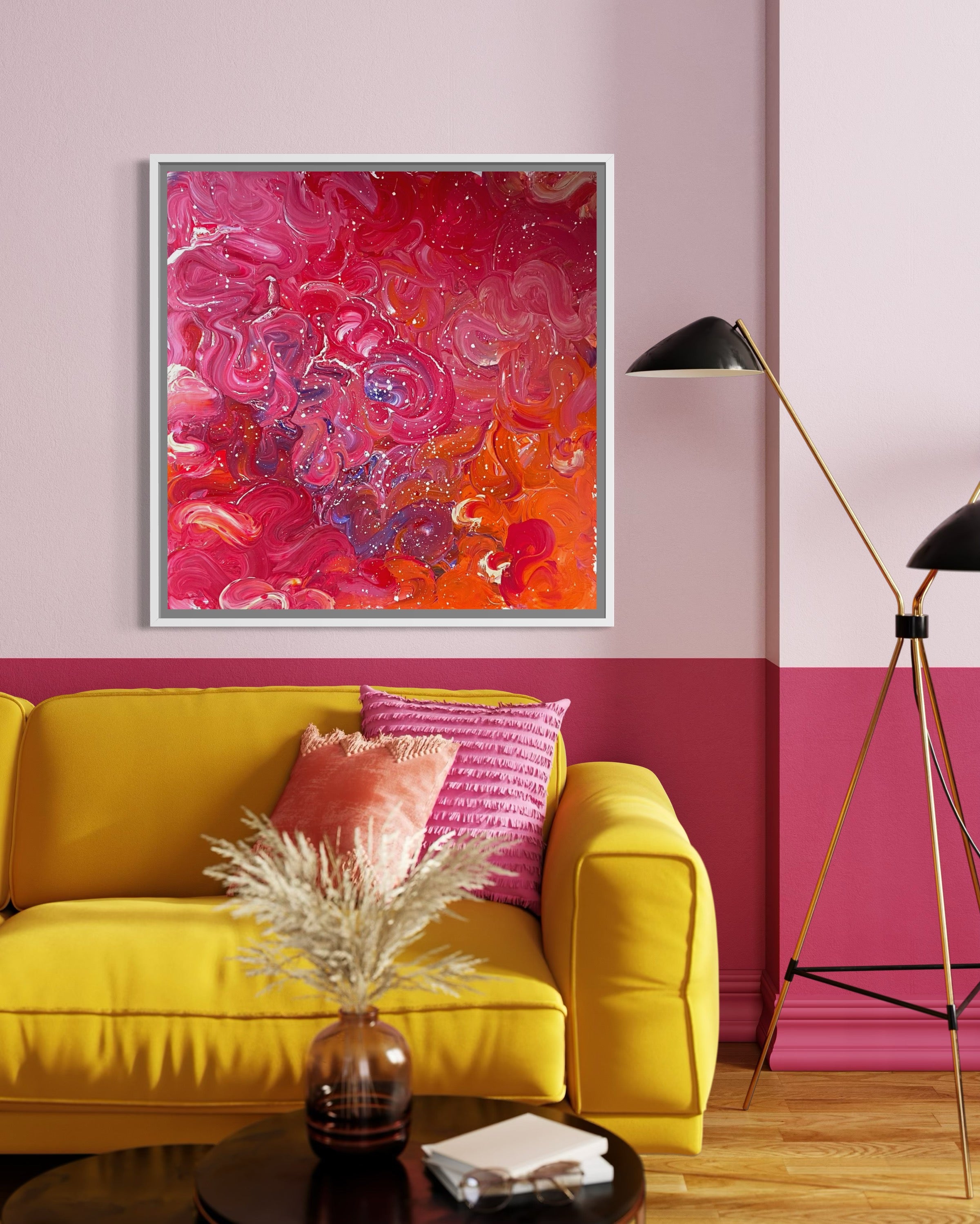 Living room with a yellow sofa, pink pillows, and a colorful abstract painting on a pink wall.