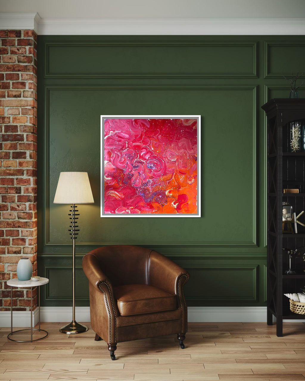 Abstract pink and red painting on a green wall with a brown leather chair and lamp.