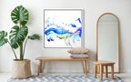 Modern interior with abstract art, plant, bench, and mirror.
