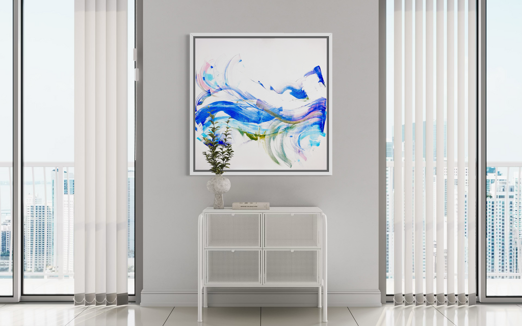 Modern interior with abstract art on a wall, white console table, and large windows.