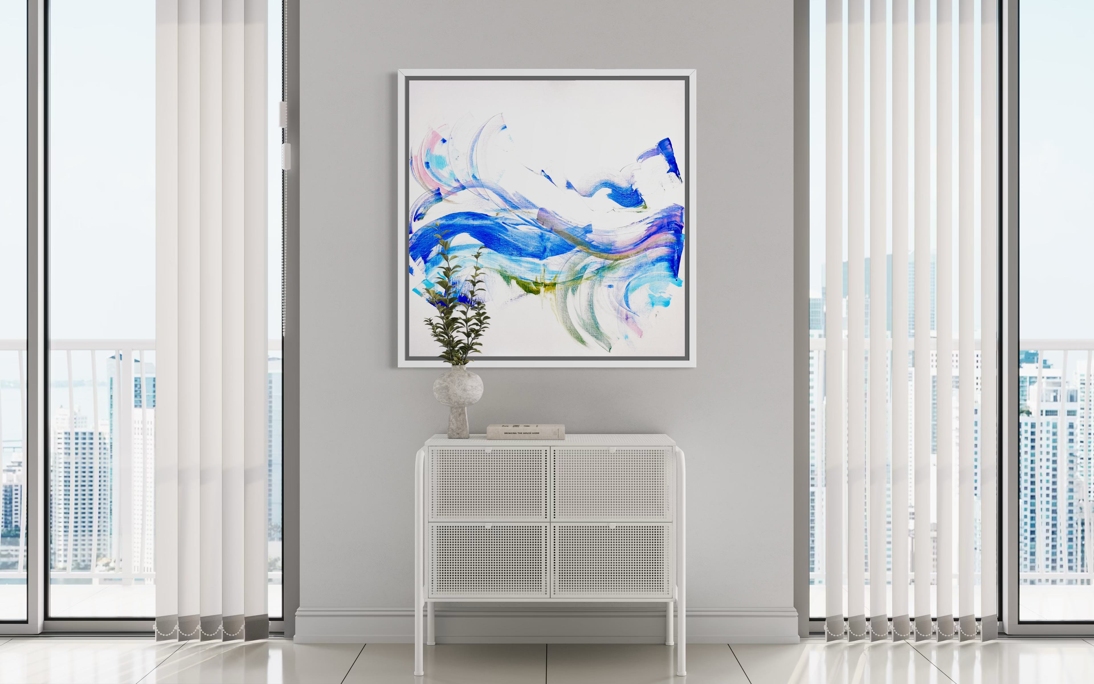 Modern interior with abstract art on a wall, white console table, and large windows.