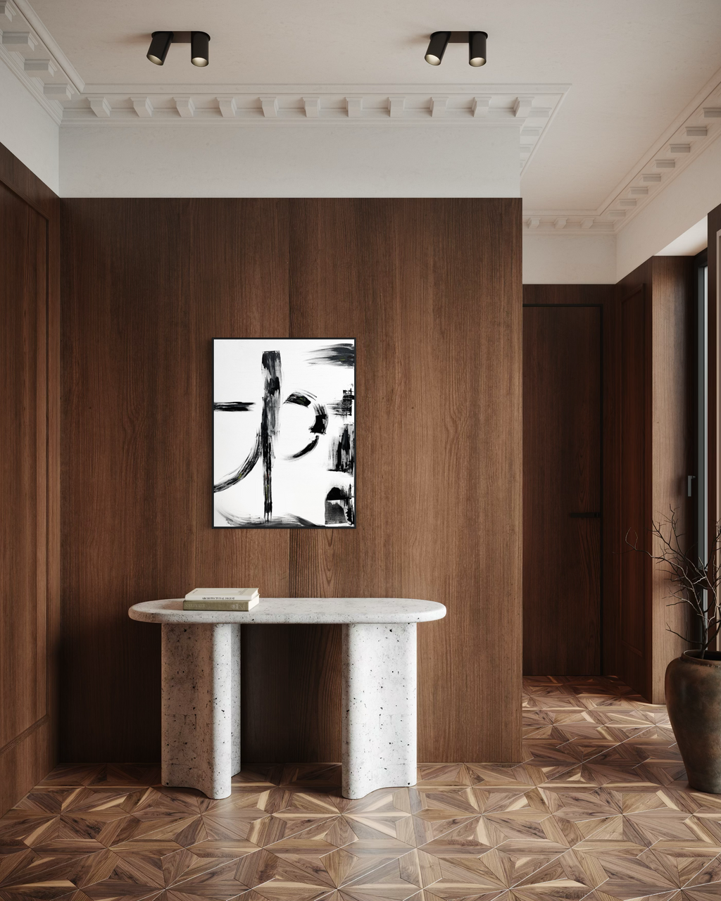 A framed black and white abstract calligraphic wall art print hangs on a dark wood-paneled wall above a white stone console table in a modern interior hallway with patterned wood floors.